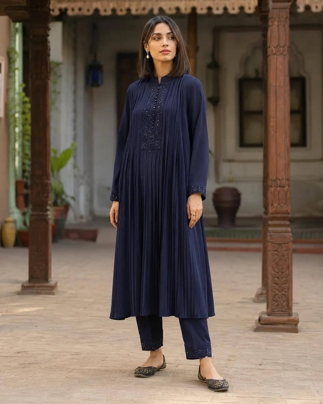 Model wearing Samira navy pleated kameez